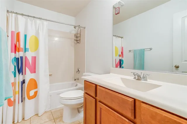 a bathroom with a sink vanity mirror and toilet