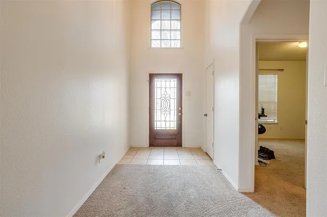 an empty room that has a window in it