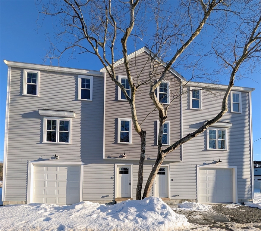 46 Holt Road, Unit B Bourne, MA 02532 - Photo 1 of 22 a front view of a house with a yard