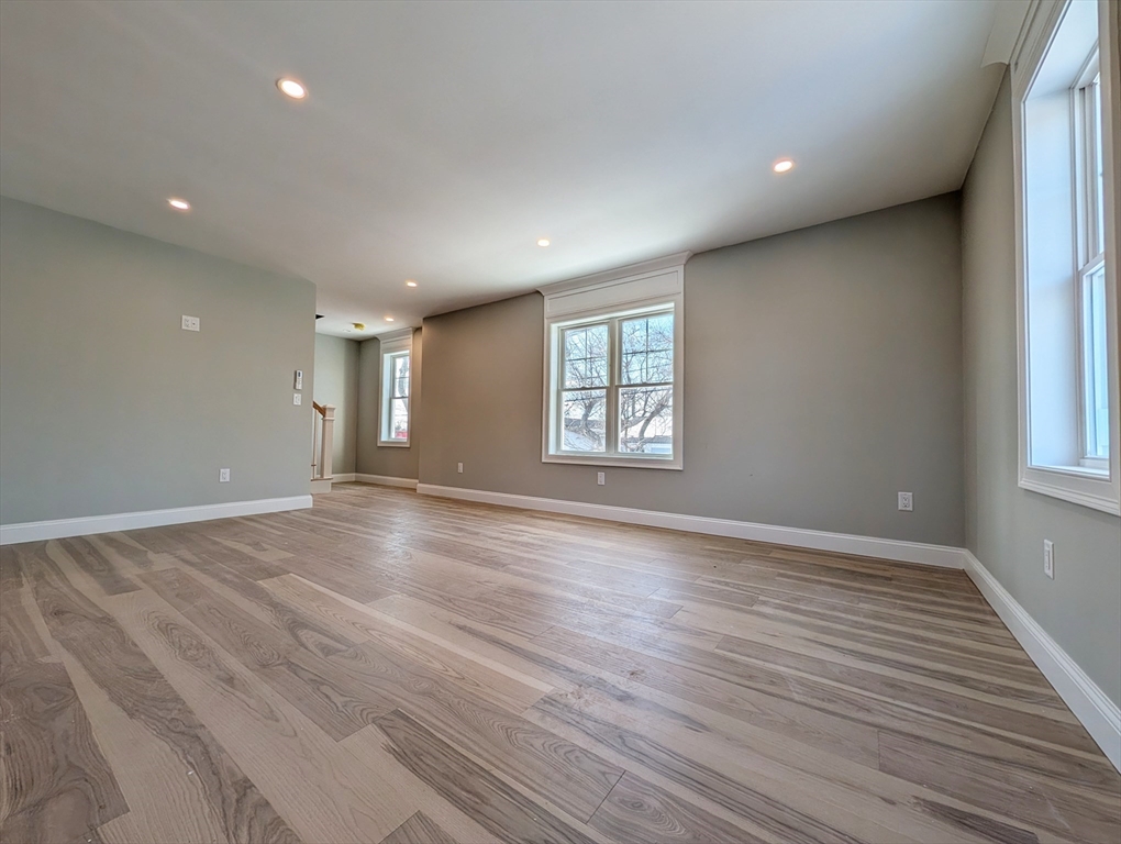 46 Holt Road, Unit B Bourne, MA 02532 - Photo 12 of 22 an empty room with wooden floor and windows