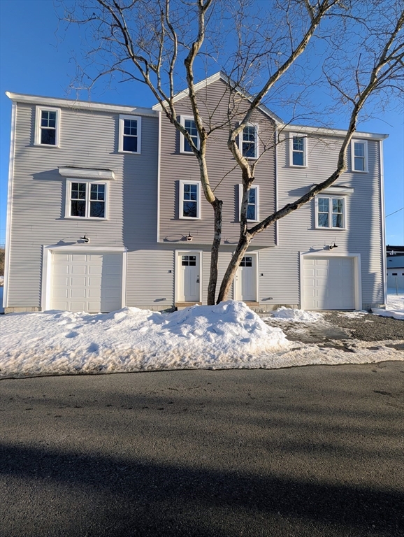 46 Holt Road, Unit B Bourne, MA 02532 - Photo 2 of 22 a front view of a house with a yard