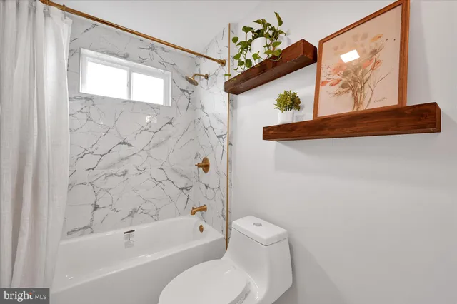 a bathroom with a sink vanity granite and toilet