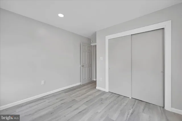 a view of hallway with wooden floor