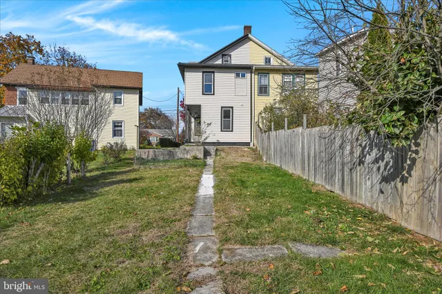 a view of a house with a yard and sitting area