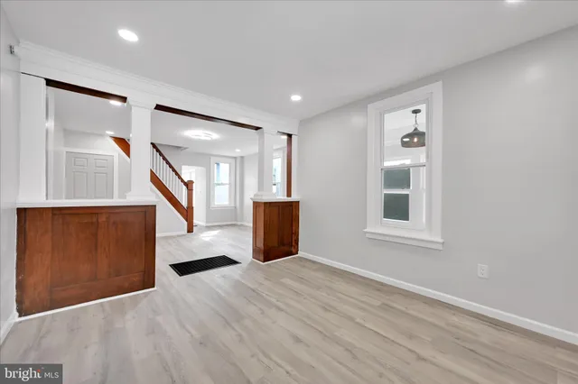 a view of a big room with wooden floor and windows
