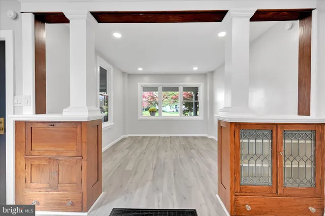 a large white kitchen with stainless steel appliances sink and cabinets