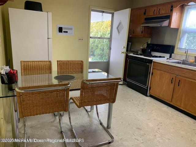 503 Wildwood Road West Allenhurst, NJ 07711 - Photo 6 of 12 a kitchen with stainless steel appliances kitchen island granite countertop a refrigerator a stove a sink dishwasher and white countertops with wooden floor