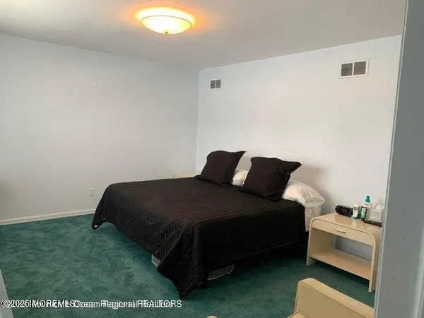 a bedroom with a bed and a chair