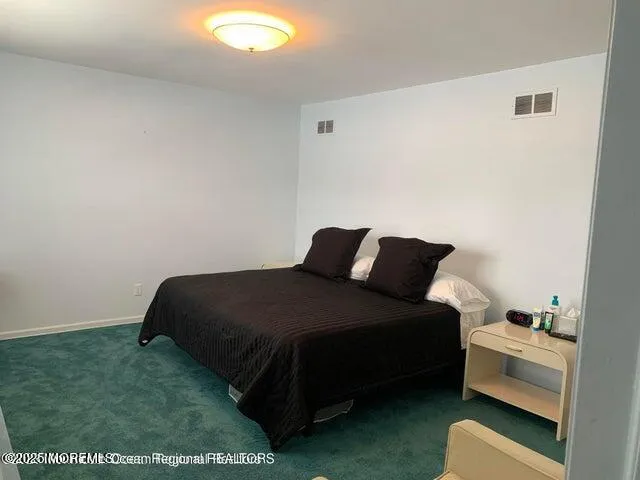 a bedroom with a bed and a chair