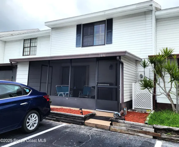 a front view of a house with parking area