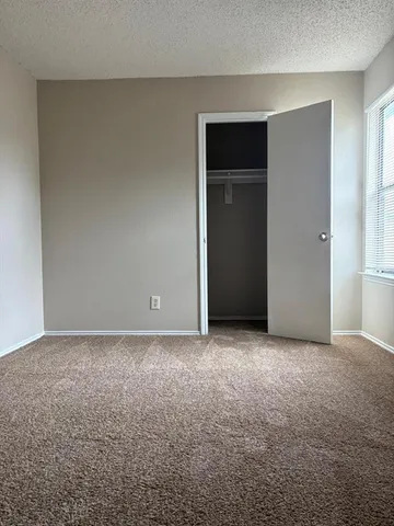a view of an empty room and closet