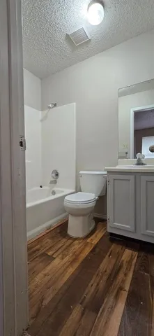 a bathroom with a toilet a sink and bathtub
