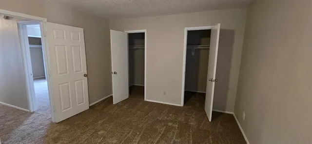 an empty room that has a grey walls