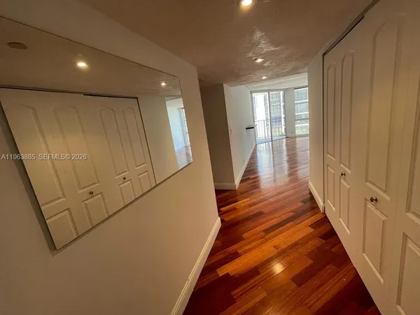 a view of a hallway with wooden floor
