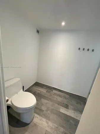 a white toilet sitting next to a white sink