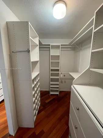 a view of walk in closet with empty racks