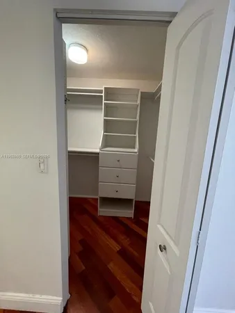a view of walk in closet with empty racks