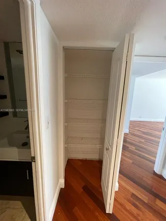 a view of staircase with white walls and railing