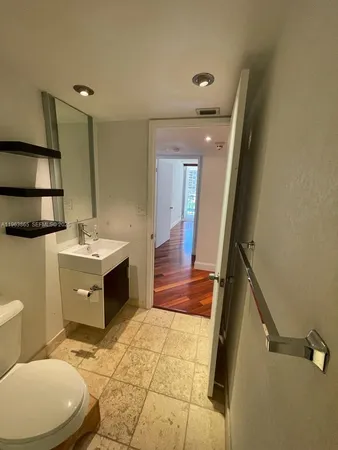 a bathroom with a sink a toilet a mirror and vanity