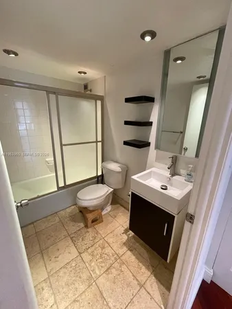 a bathroom with a sink toilet and shower