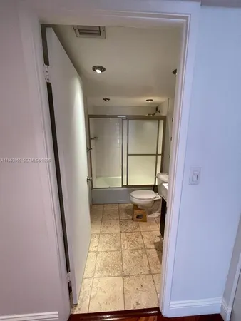 view of an empty room with wooden floor and a window