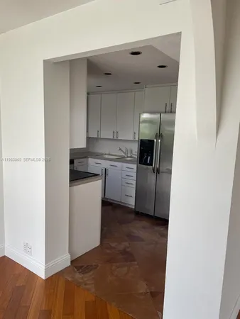 a kitchen with a refrigerator sink and cabinets