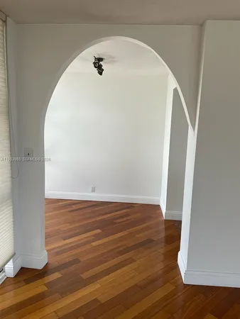 a view of a room with wooden floor