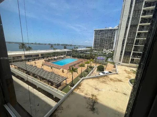 a view of a kitchen with a sink and cabinets