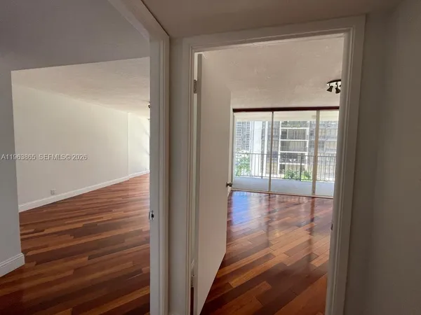 a view of hallway with wooden floor