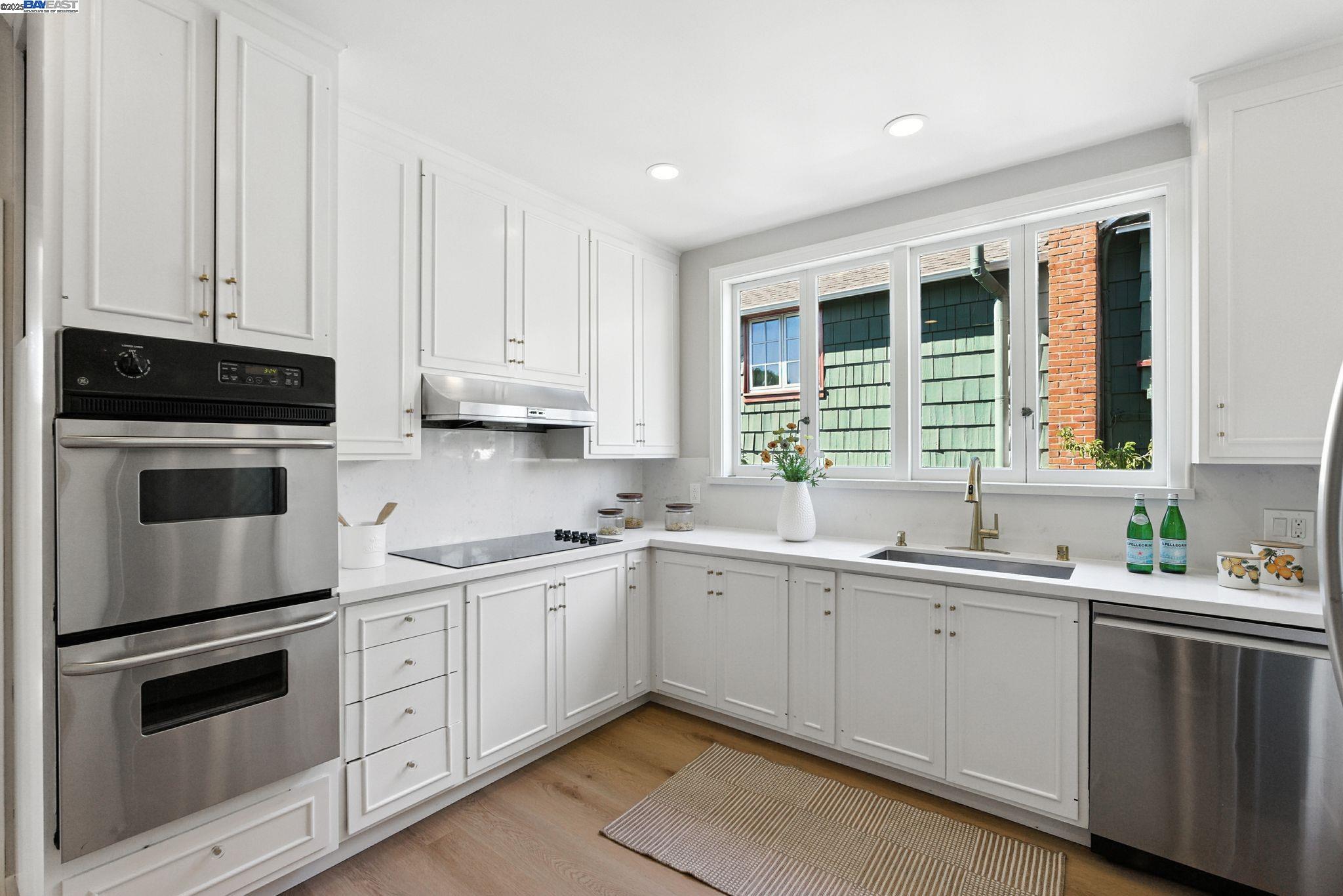 1247 Sherman Street Alameda, CA 94501 - Photo 18 of 50 a kitchen with a sink stove and cabinets