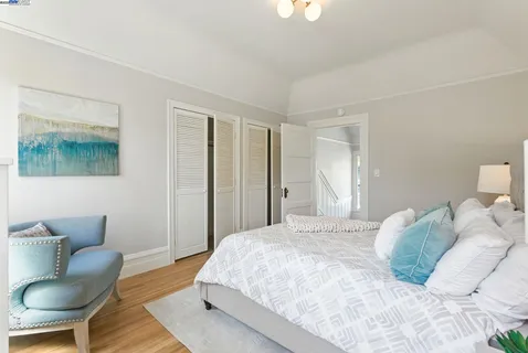 a bedroom with a bed and chair