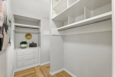 a kitchen with white cabinets and a window