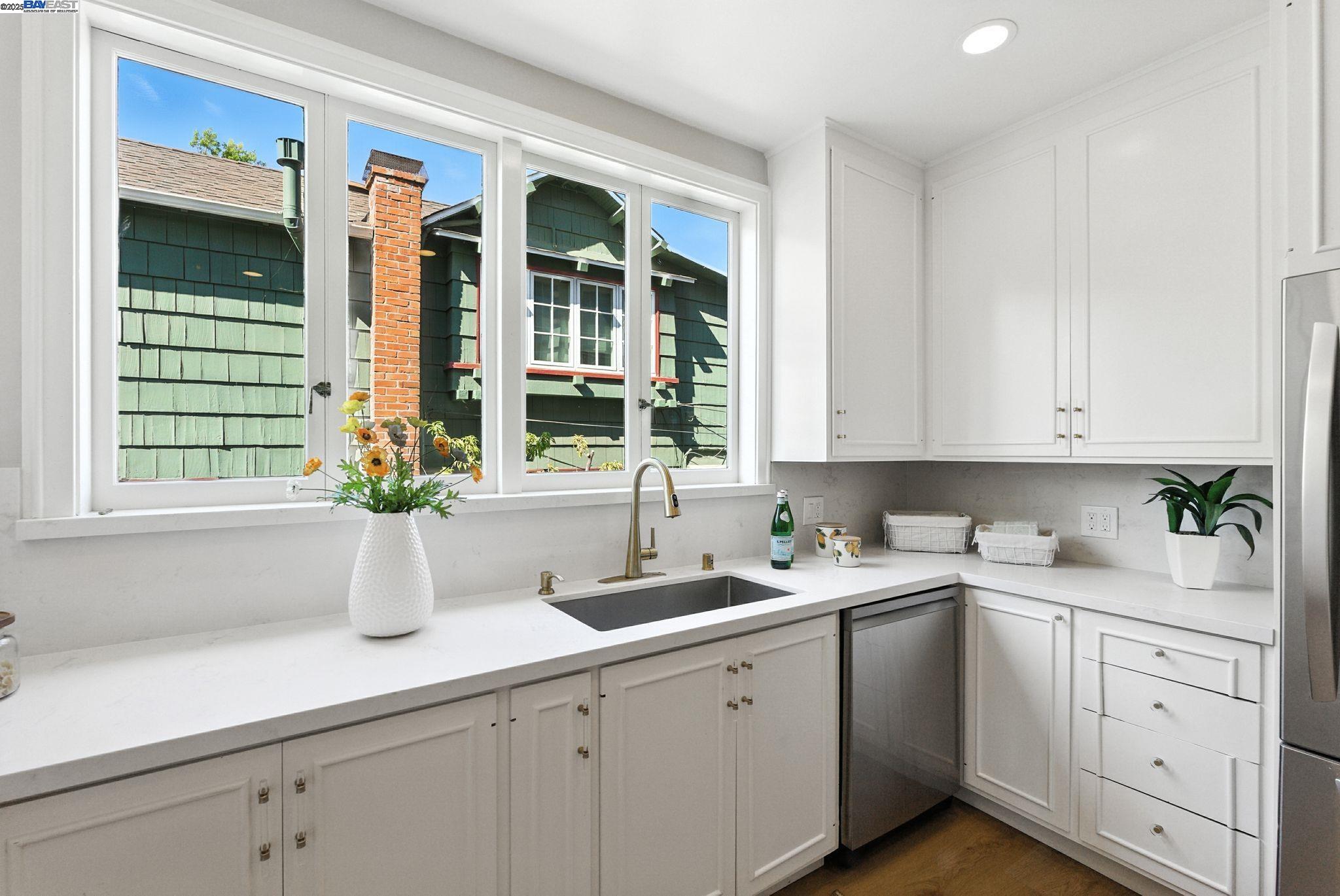 1247 Sherman Street Alameda, CA 94501 - Photo 26 of 50 a kitchen with white cabinets and a window