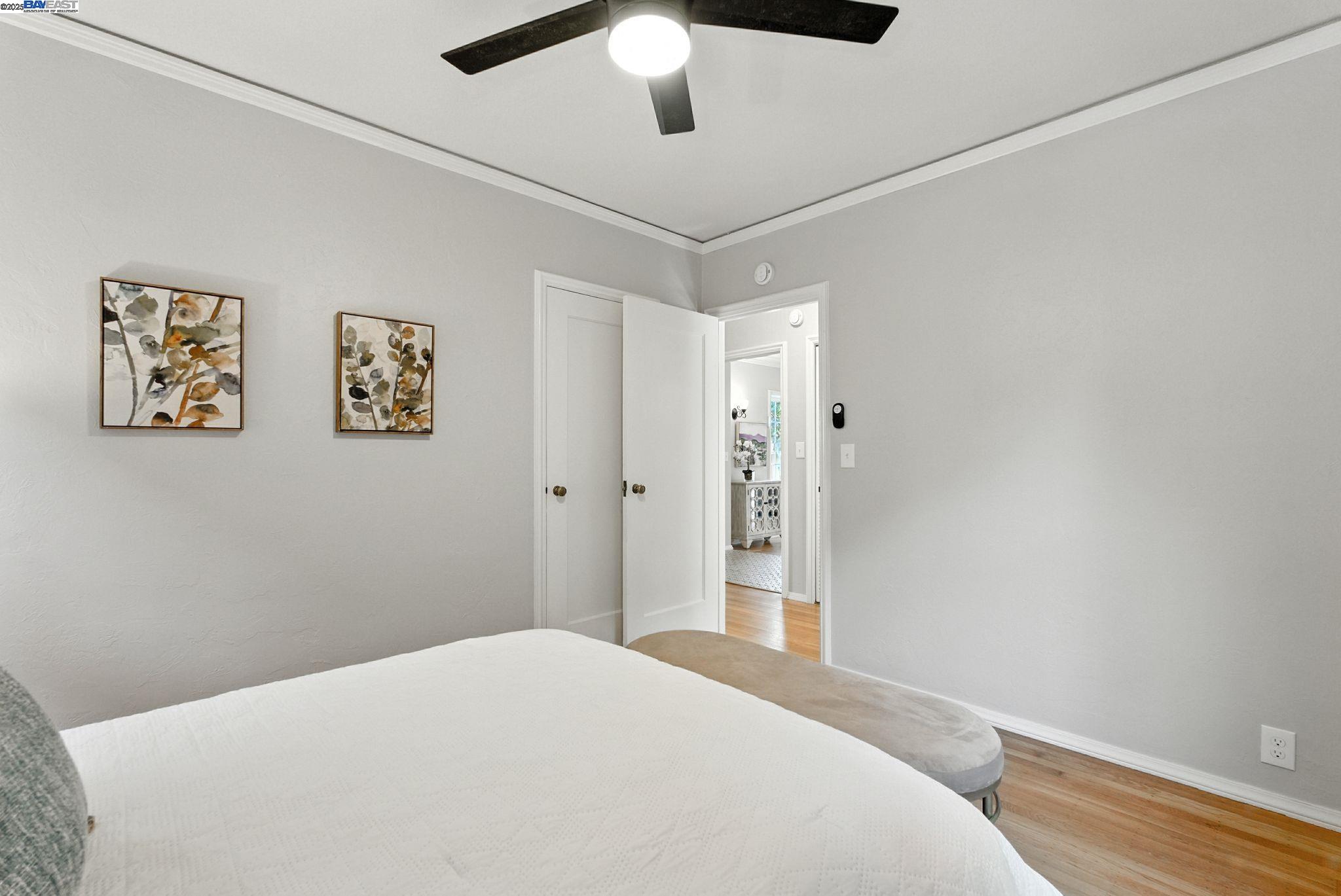 1247 Sherman Street Alameda, CA 94501 - Photo 27 of 50 a bedroom with a large bed and a chandelier