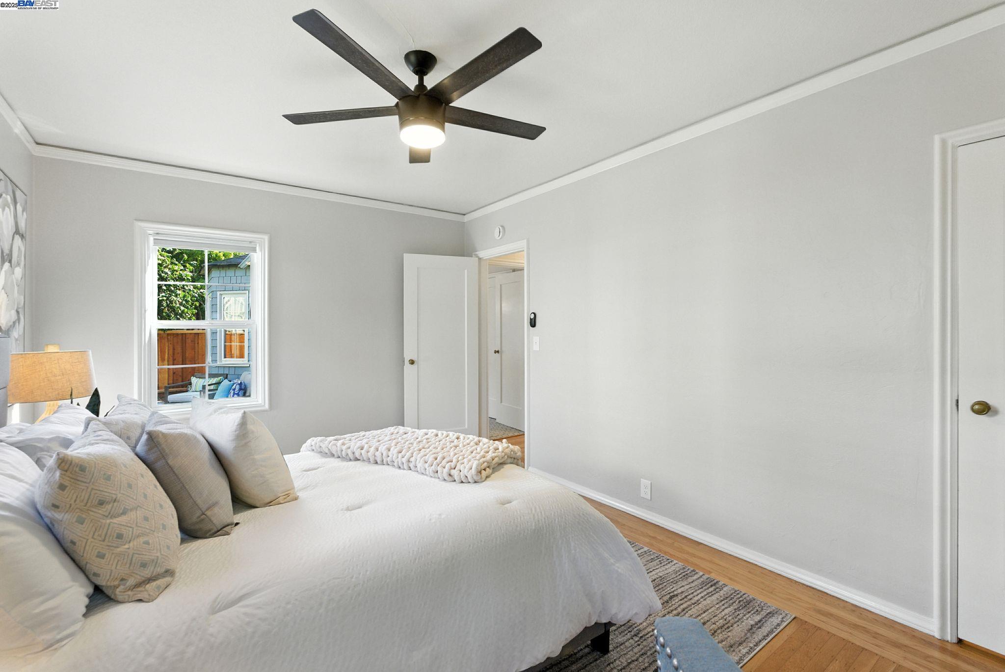 1247 Sherman Street Alameda, CA 94501 - Photo 29 of 50 a bedroom with a large bed chandelier and a window