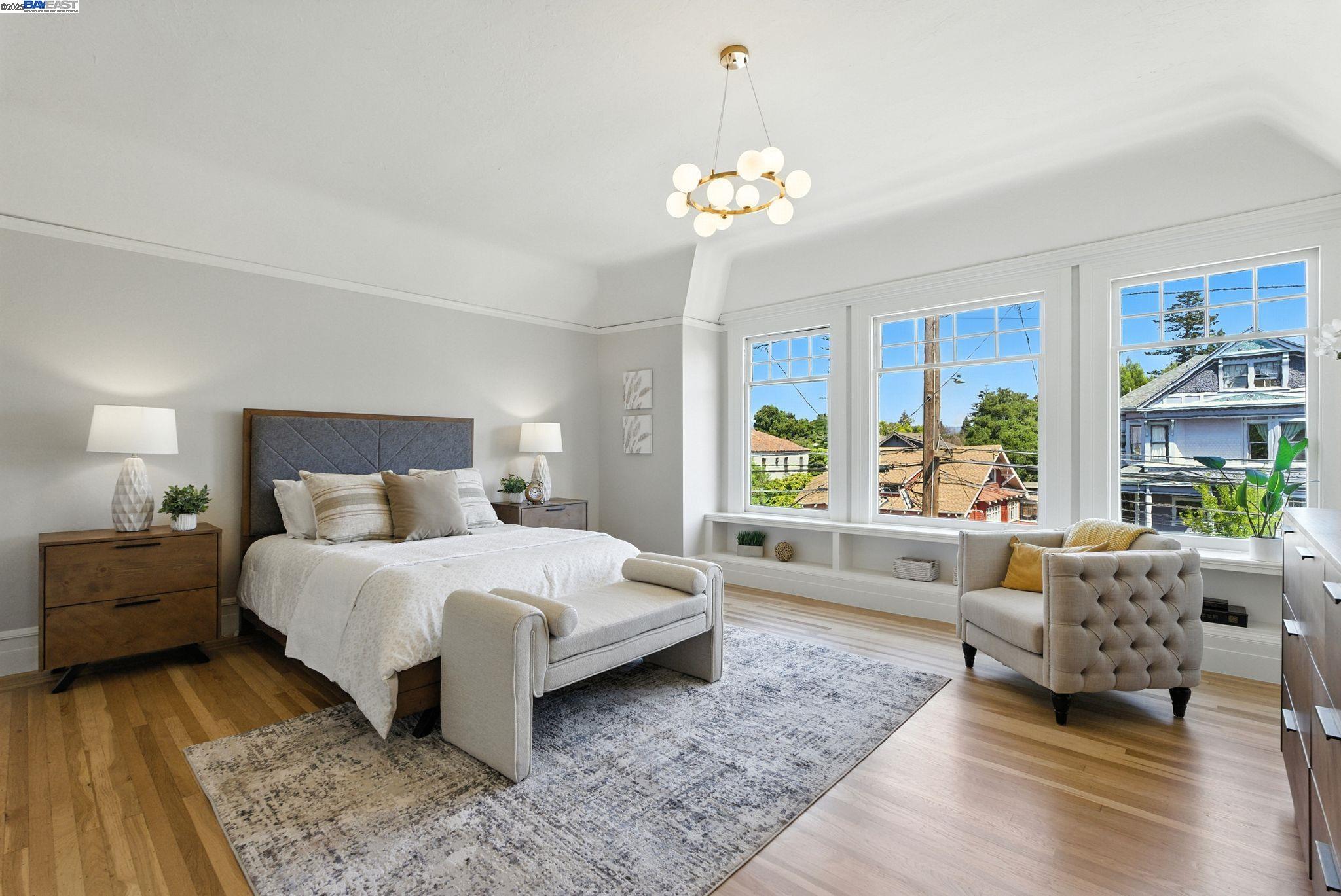 1247 Sherman Street Alameda, CA 94501 - Photo 35 of 50 a spacious bedroom with a large bed and a couch