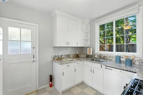 a bathroom with a granite countertop tub shower and a sink