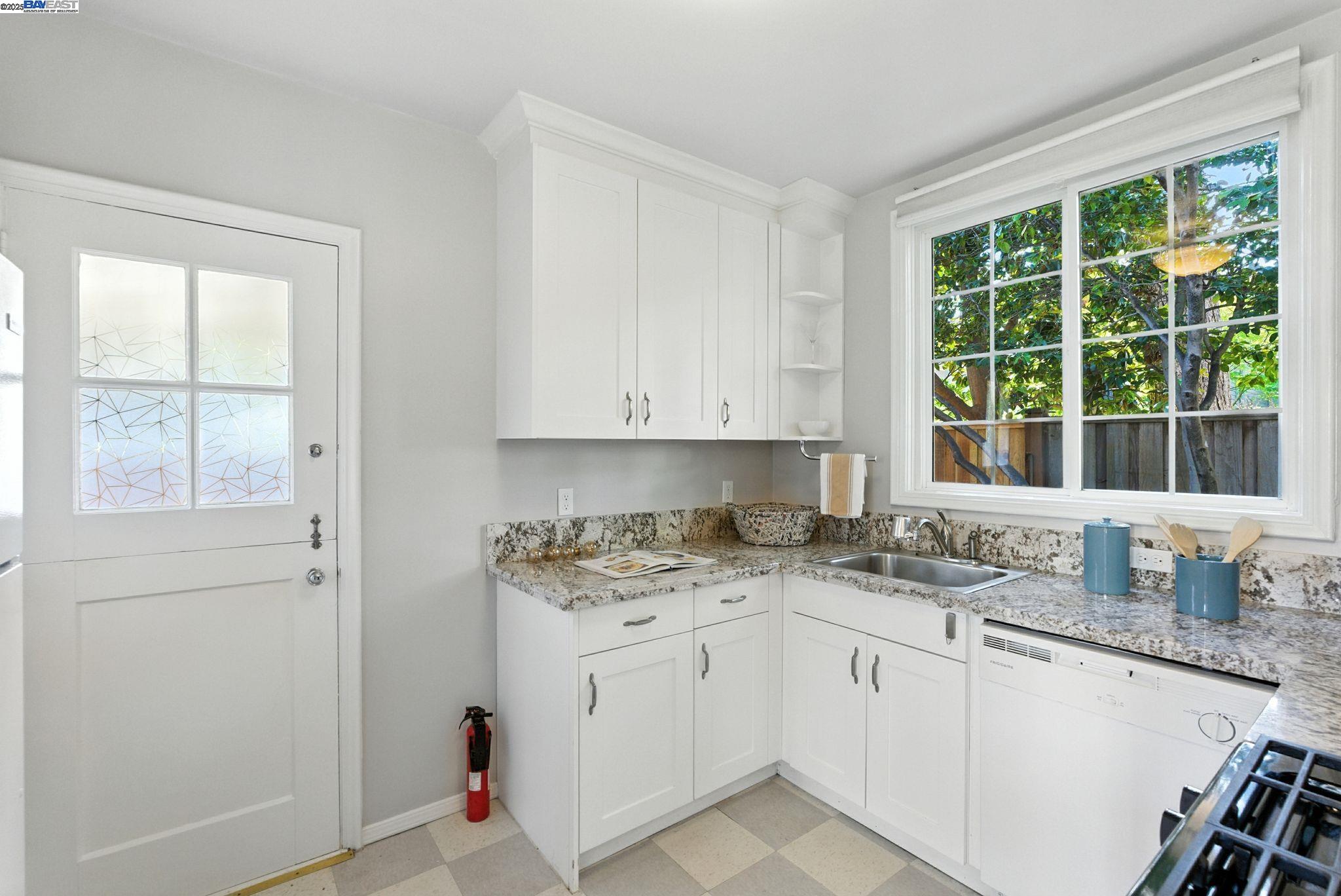 1247 Sherman Street Alameda, CA 94501 - Photo 36 of 50 a kitchen with granite countertop white cabinets and white appliances