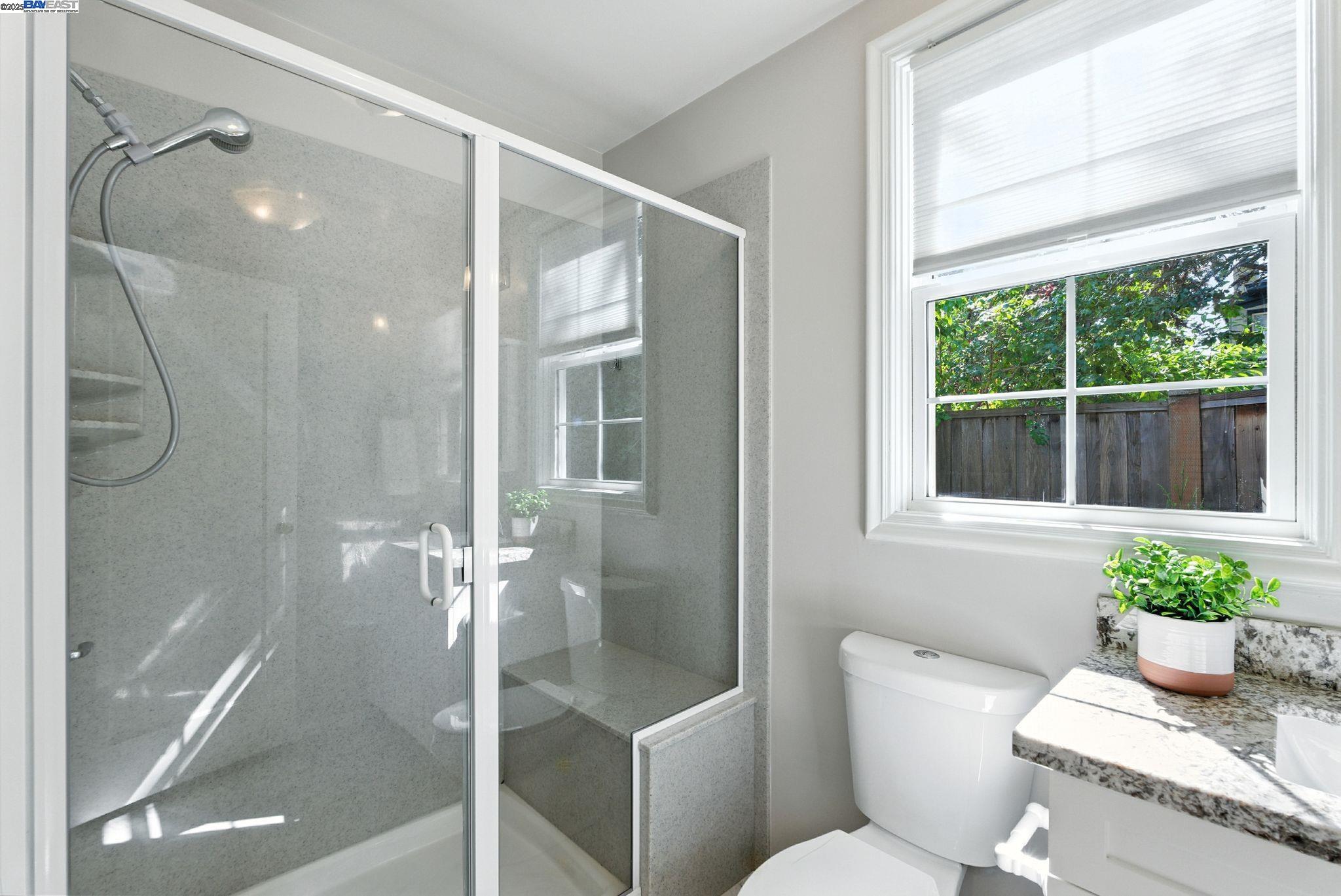 1247 Sherman Street Alameda, CA 94501 - Photo 37 of 50 a bathroom with a granite countertop tub shower and a sink