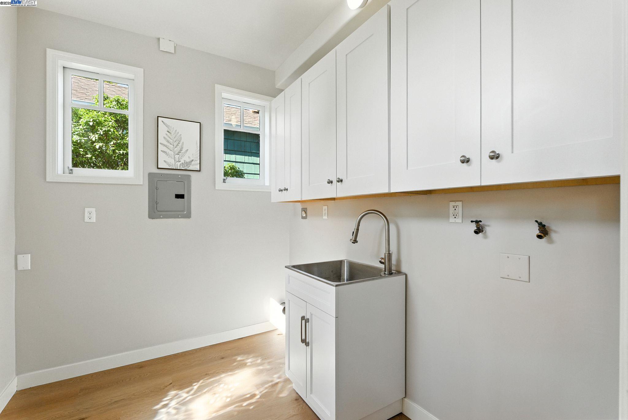1247 Sherman Street Alameda, CA 94501 - Photo 41 of 50 a kitchen with a sink and cabinets