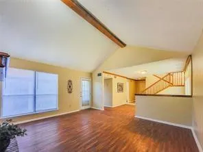 a view of a big room with wooden floor and cabinet