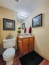 a bathroom with a toilet a sink and a mirror