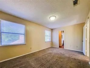 an empty room with a empty space and windows