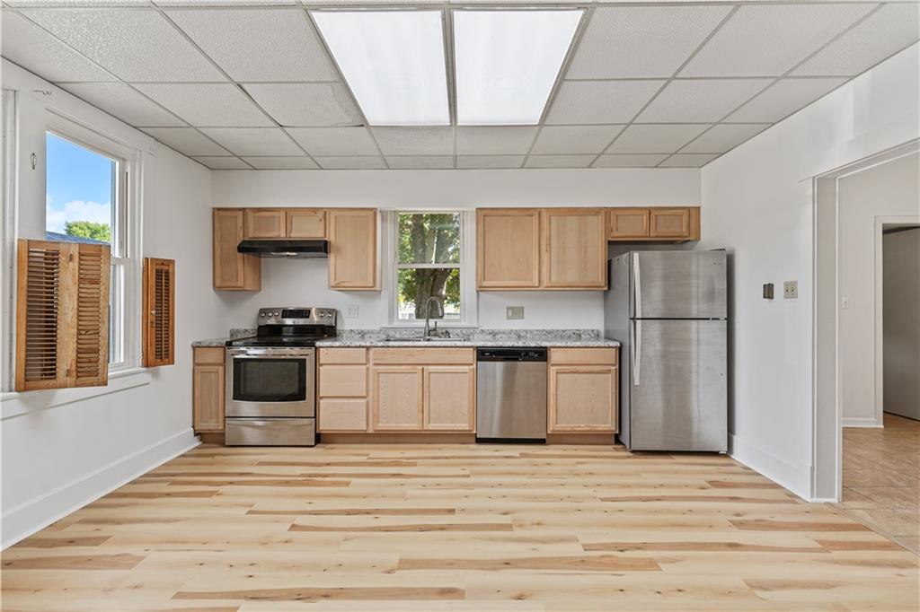 718 Mercer Road Beaver Falls, PA 15010 - Photo 14 of 44 a kitchen with a refrigerator and a stove top oven