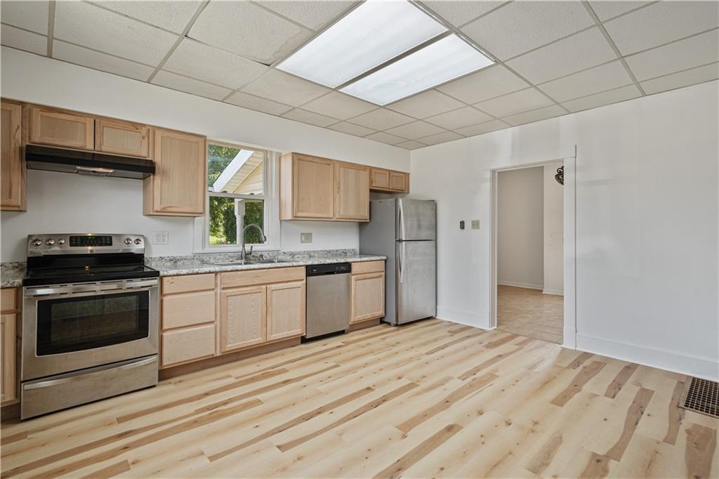 718 Mercer Road Beaver Falls, PA 15010 - Photo 17 of 44 a kitchen with stainless steel appliances a stove a sink and a refrigerator