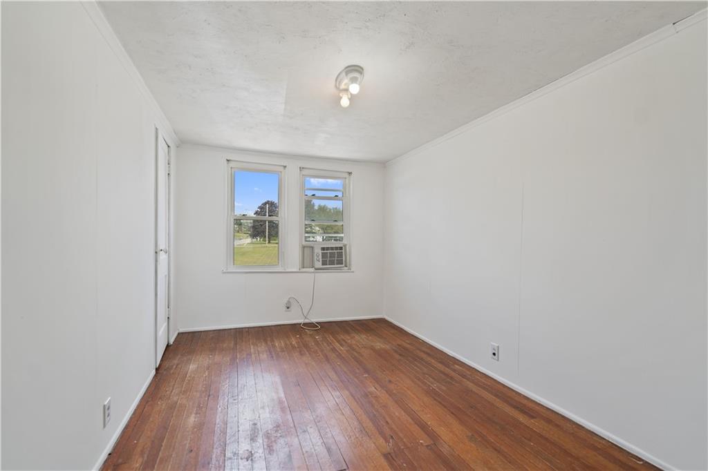 718 Mercer Road Beaver Falls, PA 15010 - Photo 26 of 44 a view of an empty room with wooden floor and a window