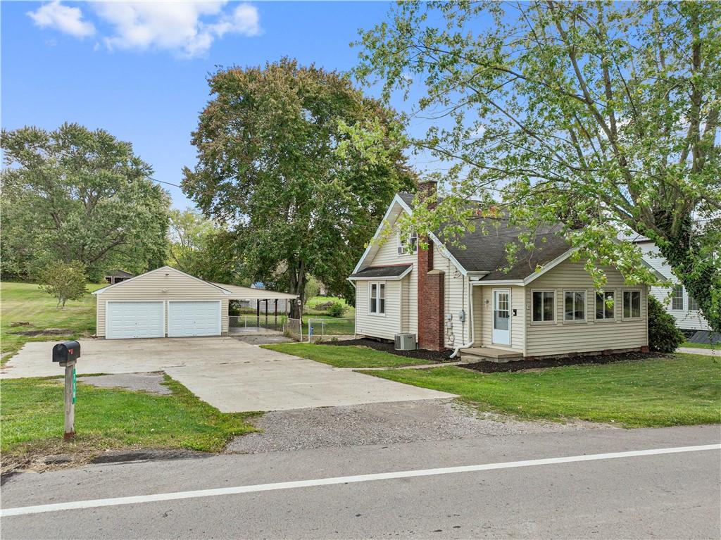 718 Mercer Road Beaver Falls, PA 15010 - Photo 44 of 44 a front view of a house with a garden and trees