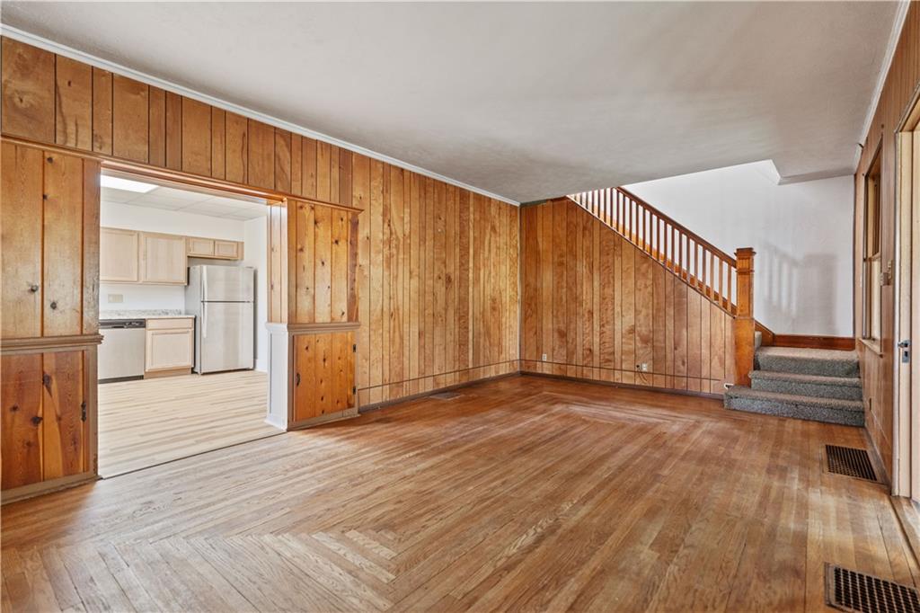 718 Mercer Road Beaver Falls, PA 15010 - Photo 9 of 44 a view of an empty room with wooden floor and a window