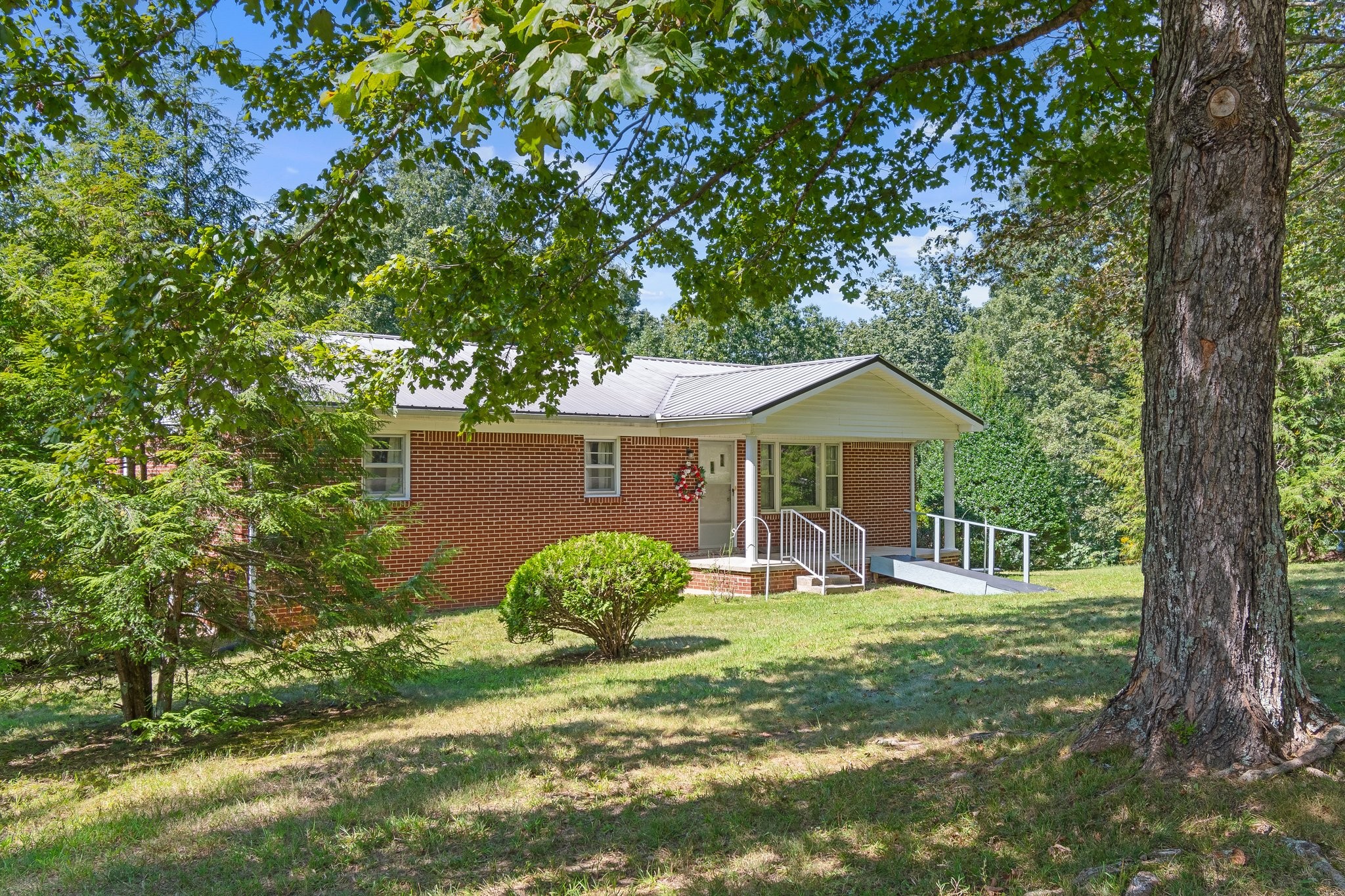 1875 Grays Bend Road Centerville, TN 37033 - Photo 1 of 33 a backyard of a house with table and chairs