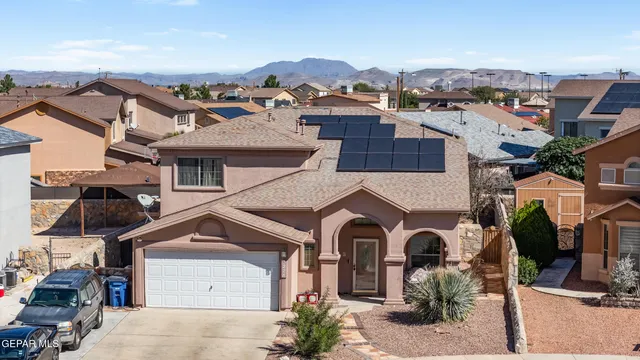 an aerial view of a house with a yard and balcony